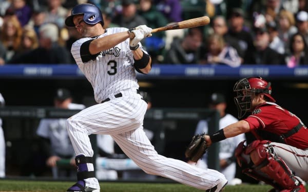 Colorado Rockies' Michael Cuddyer, left, doubles as Arizona Diamondbacks ctcher Miguel Montero looks on in the fourth inning of a baseball game in Denver on Sunday, April 6, 2014. (AP Photo/David Zalubowski)